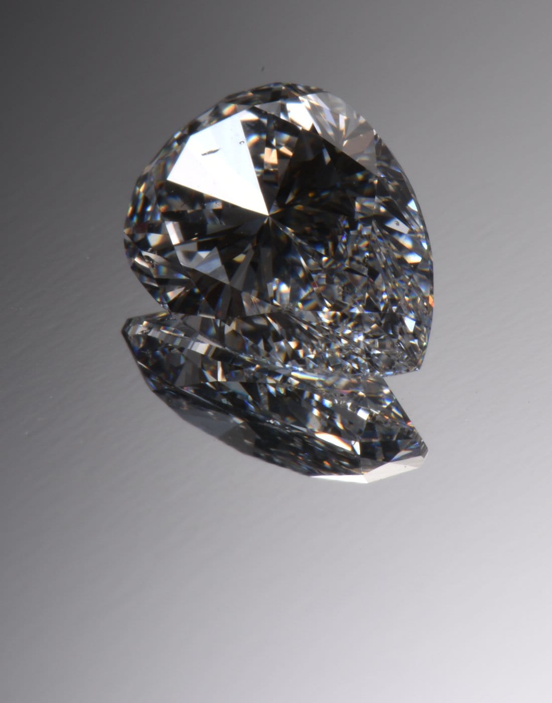 A loose white brilliant-cut diamond catching the light