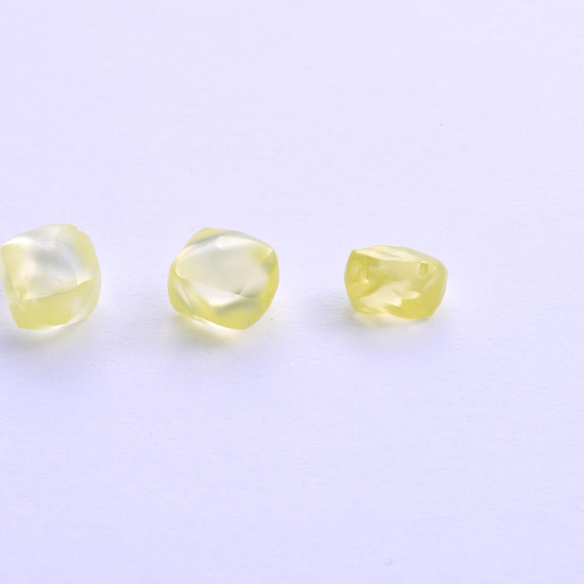Three natural fancy-yellow diamond crystals